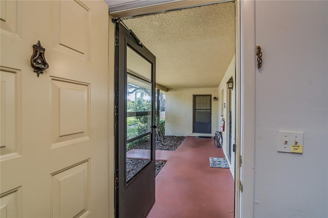 interior space featuring carpet floors and a textured ceiling