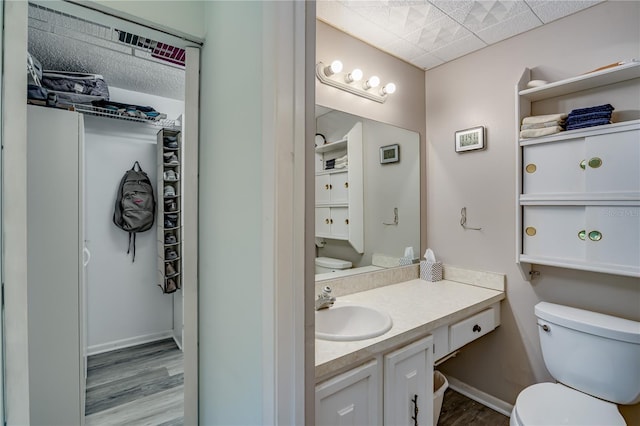 bathroom featuring vanity, hardwood / wood-style floors, and toilet