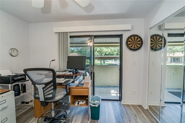 office space with ceiling fan, light hardwood / wood-style floors, and a textured ceiling