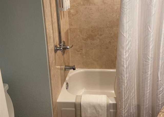 bathroom with shower / bathtub combination with curtain