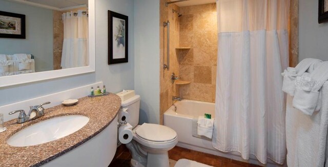 full bathroom with vanity, shower / bathtub combination with curtain, and toilet