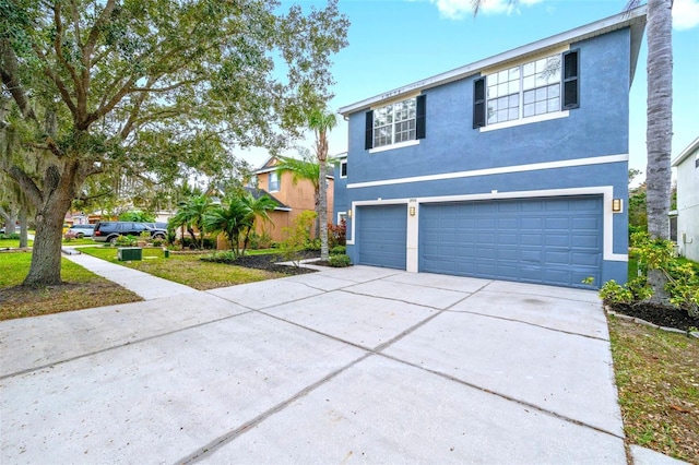 view of front of house with a garage and a front lawn