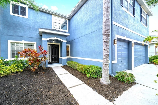 doorway to property with a garage