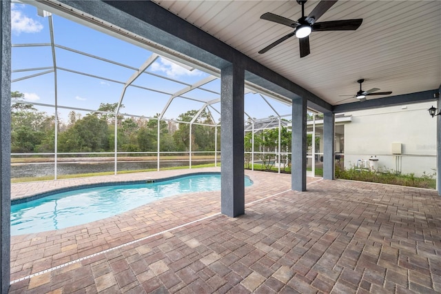 view of swimming pool featuring a lanai, a patio area, and ceiling fan