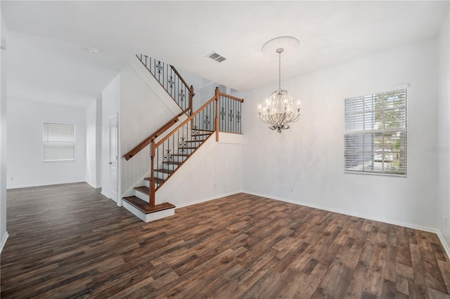 interior space with dark hardwood / wood-style flooring and a notable chandelier