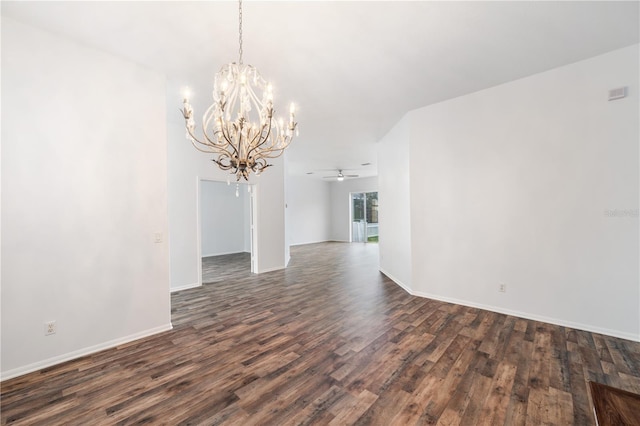 spare room with dark wood-type flooring and ceiling fan with notable chandelier