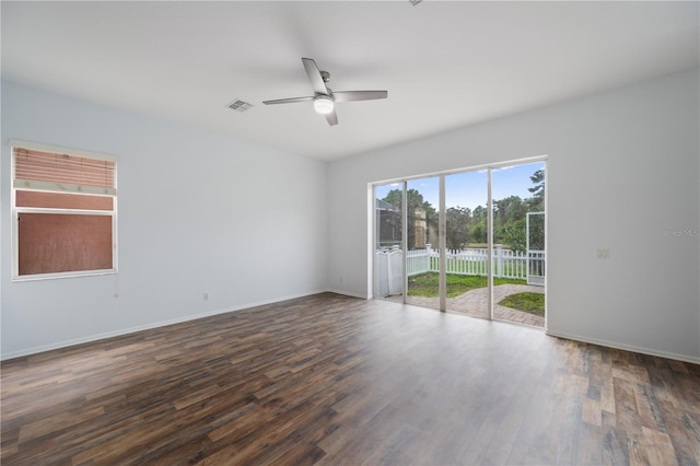 spare room with dark wood-type flooring and ceiling fan