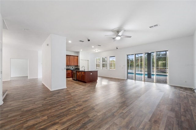 unfurnished living room featuring ceiling fan and dark hardwood / wood-style floors