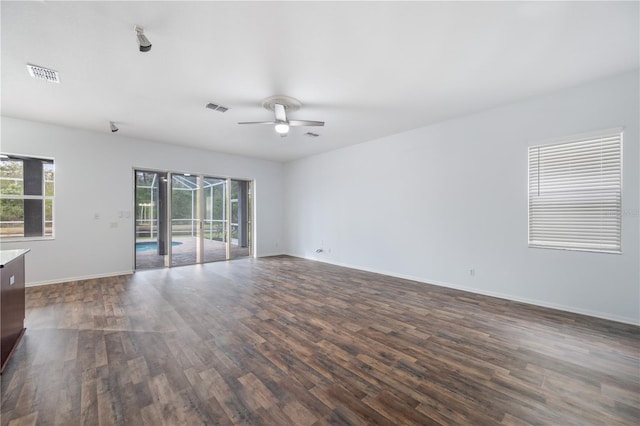 empty room with dark wood-type flooring and ceiling fan