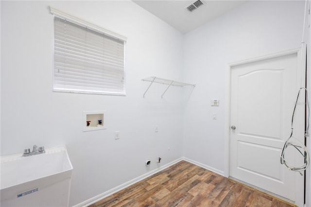 laundry room featuring hardwood / wood-style flooring, washer hookup, gas dryer hookup, and sink