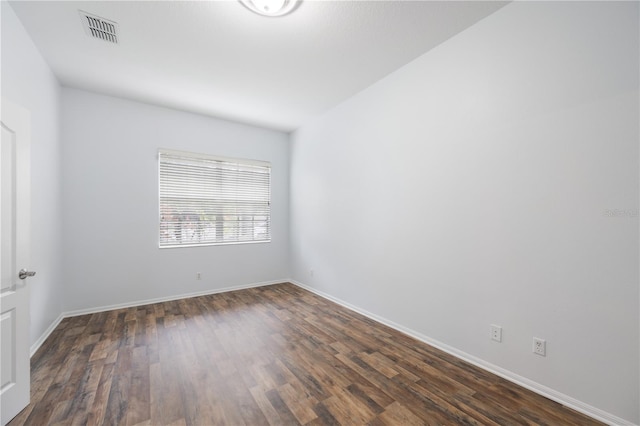 unfurnished room featuring dark hardwood / wood-style flooring