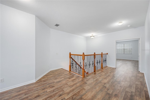 unfurnished room with wood-type flooring