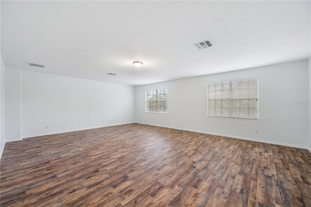 empty room featuring dark wood-type flooring