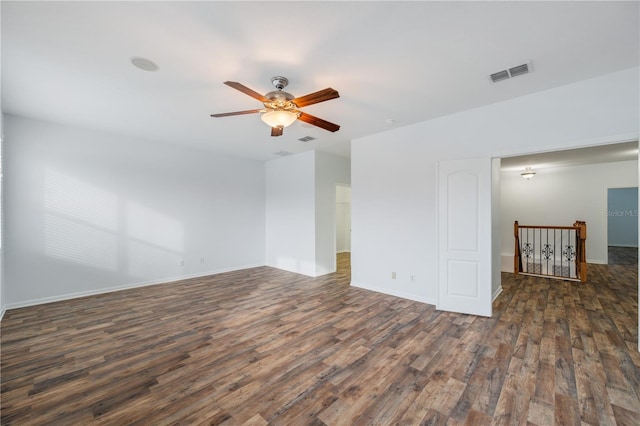 empty room with ceiling fan and dark hardwood / wood-style flooring