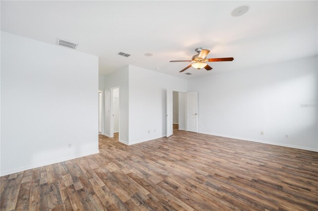 empty room featuring dark wood-type flooring and ceiling fan