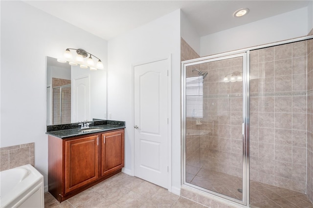 bathroom featuring vanity, tile patterned flooring, and shower with separate bathtub