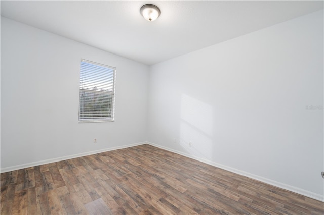 spare room featuring dark hardwood / wood-style flooring