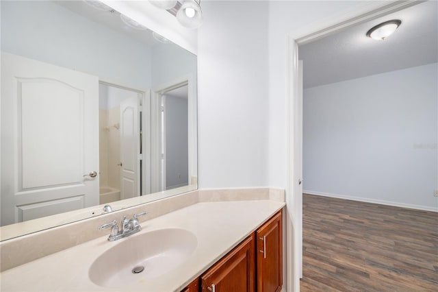 bathroom with hardwood / wood-style flooring, vanity, and a textured ceiling