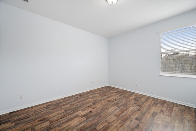 spare room featuring dark wood-type flooring