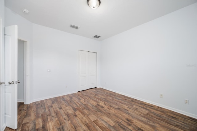 unfurnished room with dark hardwood / wood-style flooring