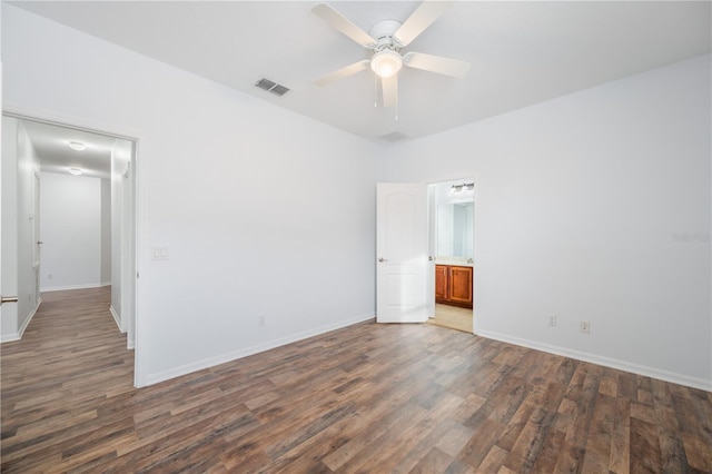 spare room with ceiling fan and dark hardwood / wood-style flooring