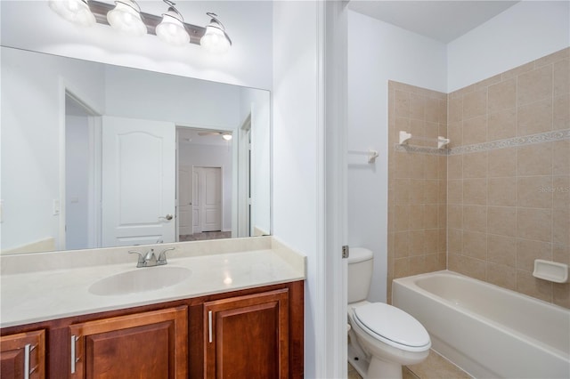 full bathroom with vanity, tiled shower / bath combo, and toilet