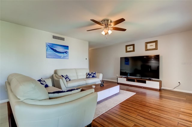 living room with hardwood / wood-style flooring and ceiling fan