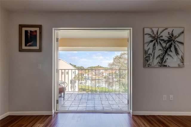 doorway to outside featuring hardwood / wood-style floors and a water view