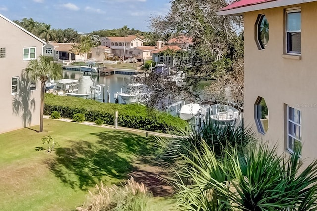 exterior space featuring a water view and a yard