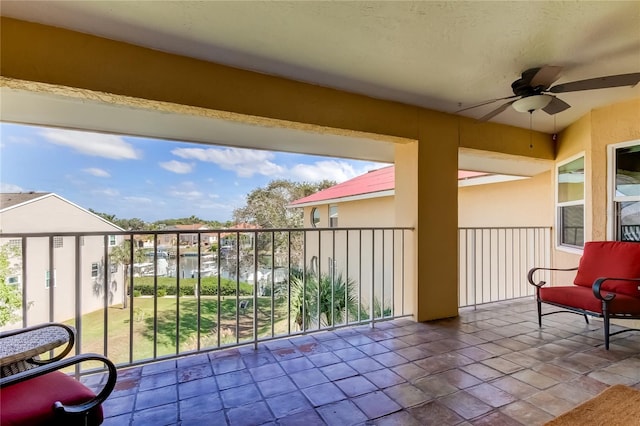 view of patio / terrace featuring ceiling fan and a water view