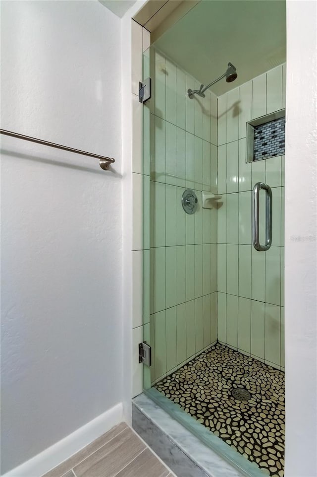 bathroom with a shower with shower door