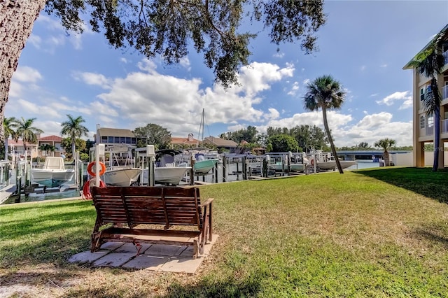 view of property's community with a boat dock, a water view, and a lawn