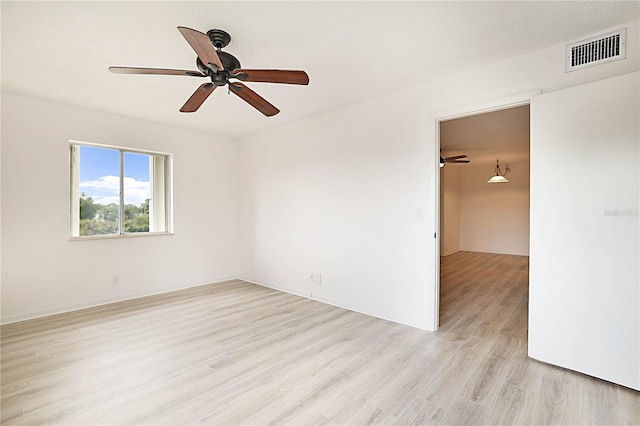 unfurnished room with ceiling fan, a textured ceiling, and light hardwood / wood-style floors