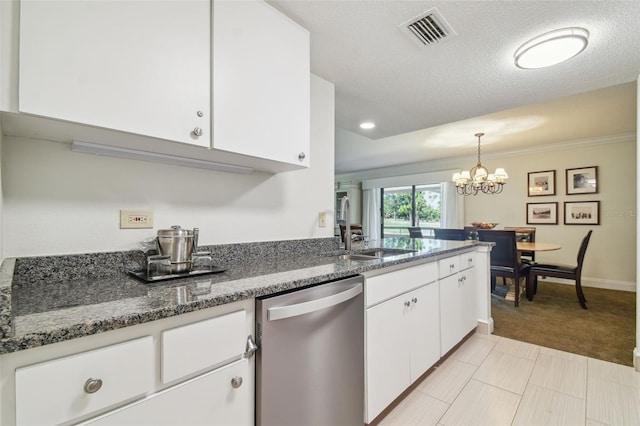 kitchen featuring white cabinetry, dishwasher, a notable chandelier, dark stone countertops, and light colored carpet