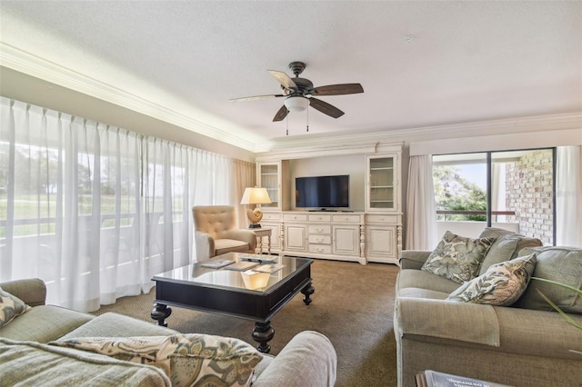 carpeted living room with a textured ceiling, ceiling fan, and crown molding