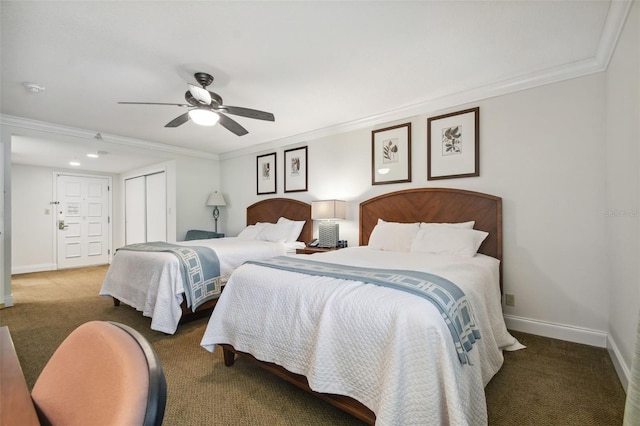 carpeted bedroom featuring ceiling fan, ornamental molding, and a closet