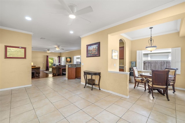 kitchen featuring light tile patterned floors, hanging light fixtures, crown molding, and ceiling fan