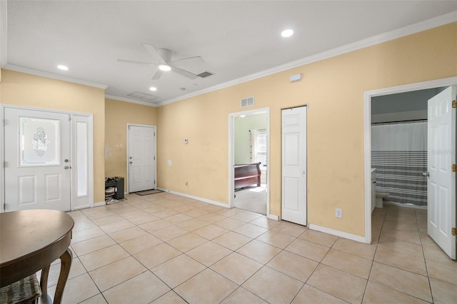 entrance foyer featuring light tile patterned floors, ceiling fan, and crown molding