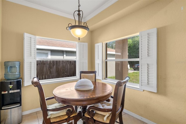 tiled dining space featuring ornamental molding