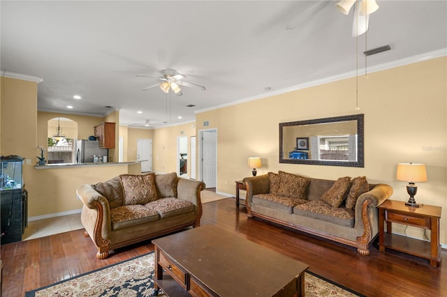 living room featuring hardwood / wood-style flooring, ceiling fan, and ornamental molding