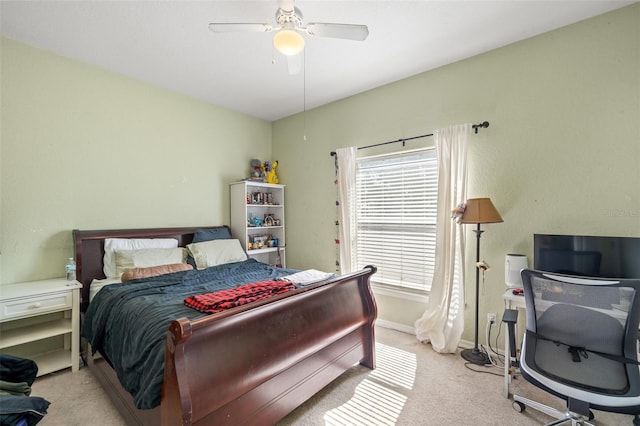 bedroom with ceiling fan and light carpet