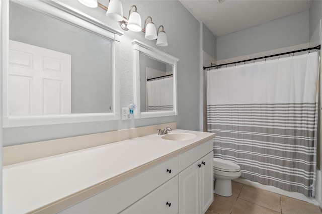 bathroom featuring tile patterned flooring, vanity, and toilet