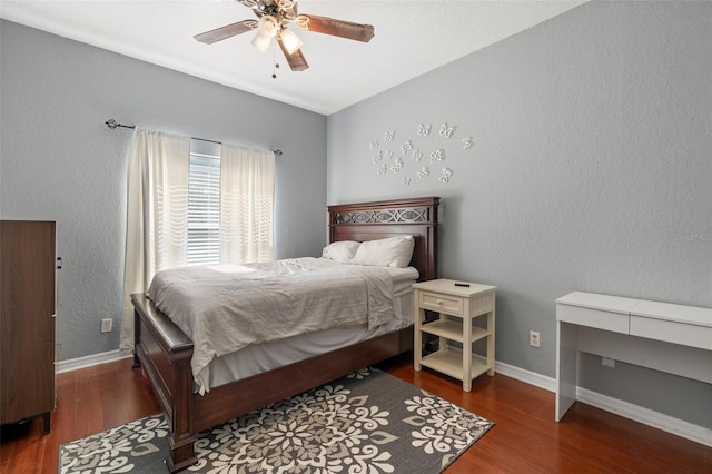 bedroom with dark hardwood / wood-style flooring and ceiling fan