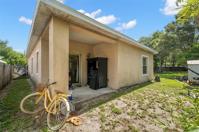 rear view of house with a yard and a patio area