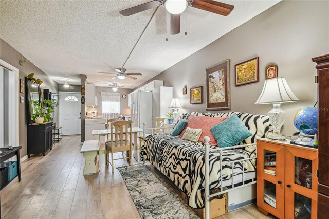 bedroom featuring light hardwood / wood-style floors and a textured ceiling