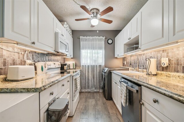 kitchen featuring ceiling fan, white cabinetry, light hardwood / wood-style flooring, and white appliances