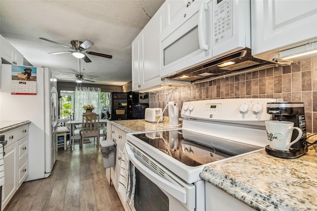 kitchen featuring decorative backsplash, dark hardwood / wood-style flooring, white appliances, and white cabinets