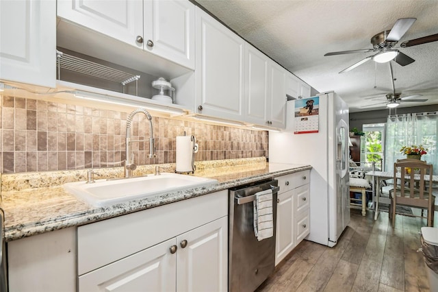 kitchen featuring sink, light wood-type flooring, dishwasher, a textured ceiling, and white cabinets