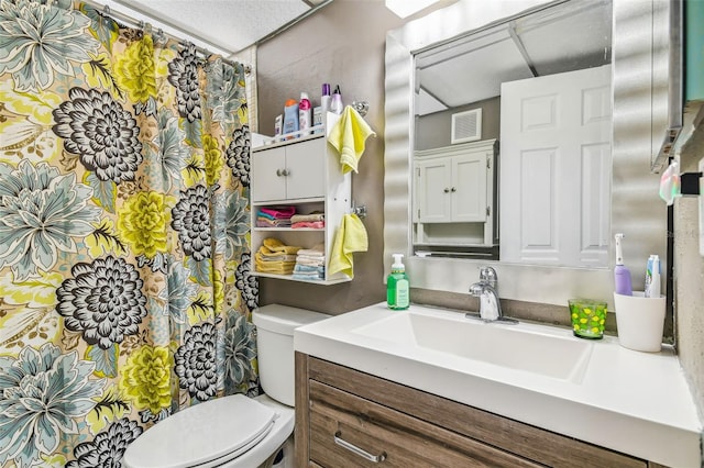 bathroom with toilet and vanity