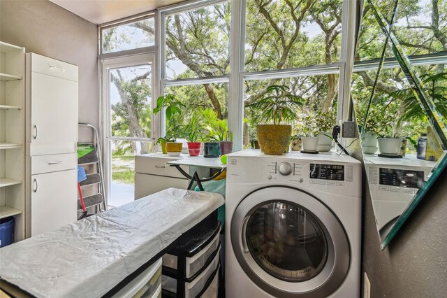 clothes washing area featuring washer / clothes dryer